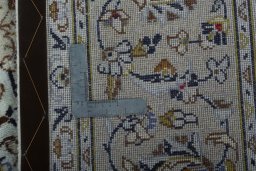 Backside of handmade 2000s Kashan rug showing knot structure and weave density