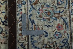 Backside of handmade New Kashan rug showing knot structure and weave density
