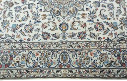 Corner detail of 2000s Kashan rug showing border pattern and Wool pile