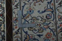 Backside of handmade 2000s Kashan rug showing knot structure and weave density