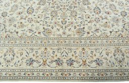 Corner detail of 2000s Kashan rug showing border pattern and Wool pile