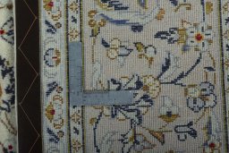 Backside of handmade 2000s Kashan rug showing knot structure and weave density