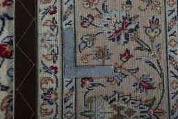Backside of handmade New Kashan rug showing knot structure and weave density