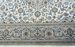 Corner detail of 2000s Kashan rug showing border pattern and Wool pile