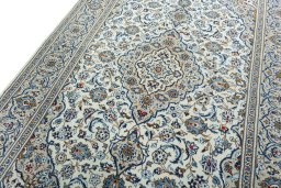 Backside of handmade 2000s Kashan rug showing knot structure and weave density