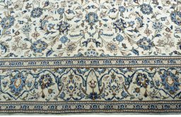 Corner detail of New Kashan rug showing border pattern and Wool pile