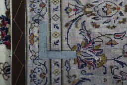 Backside of handmade 2000s Kashan rug showing knot structure and weave density