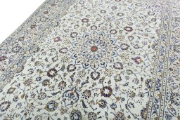 Backside of handmade 2000s Kashan rug showing knot structure and weave density