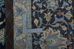 Backside of handmade 1970s Kashan rug showing knot structure and weave density
