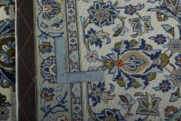 Backside of handmade New Kashan rug showing knot structure and weave density