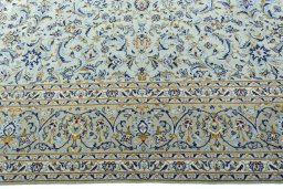 Corner detail of 2000s Kashan rug showing border pattern and Wool pile