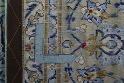 Backside of handmade 2000s Kashan rug showing knot structure and weave density