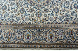 Corner detail of 2000s Kashan rug showing border pattern and Wool pile
