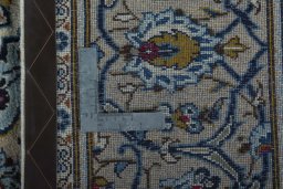 Backside of handmade 2000s Kashan rug showing knot structure and weave density
