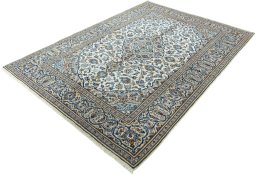 Corner detail of 2000s Kashan rug showing border pattern and Wool pile