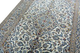 Backside of handmade 2000s Kashan rug showing knot structure and weave density