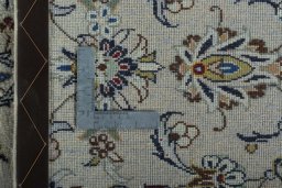 Backside of handmade New Kashan rug showing knot structure and weave density