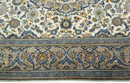 Corner detail of 2000s Kashan rug showing border pattern and Wool pile