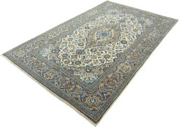 Corner detail of 2000s Kashan rug showing border pattern and Wool pile