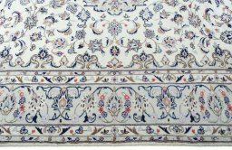 Corner detail of 2000s Kashan rug showing border pattern and Wool pile
