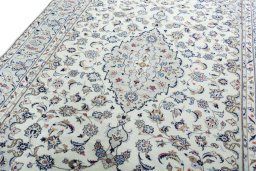 Backside of handmade 2000s Kashan rug showing knot structure and weave density