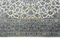Corner detail of 2000s Kashan rug showing border pattern and Cork pile