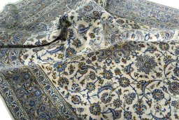 Surface texture of 2000s Kashan rug with natural Cork and intricate pattern