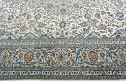 Corner detail of 2000s Kashan rug showing border pattern and Wool pile