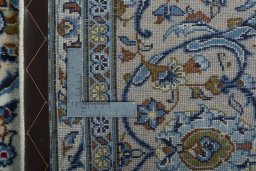Backside of handmade 2000s Kashan rug showing knot structure and weave density