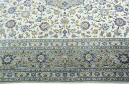 Corner detail of 2000s Kashan rug showing border pattern and Cork pile