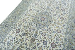 Backside of handmade 2000s Kashan rug showing knot structure and weave density