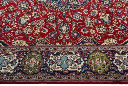 Corner detail of 2000s Kashan rug showing border pattern and Wool pile