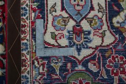Backside of handmade 2000s Kashan rug showing knot structure and weave density