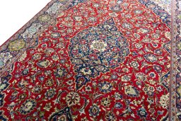 Backside of handmade 2000s Kashan rug showing knot structure and weave density