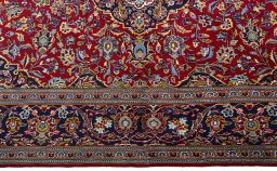 Corner detail of New Kashan rug showing border pattern and Cork pile
