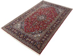 Corner detail of New Kashan rug showing border pattern and Cork pile