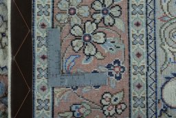 Backside of handmade New Kashan rug showing knot structure and weave density