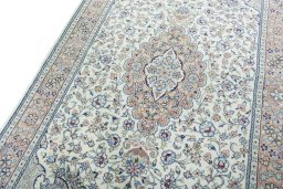 Backside of handmade New Kashan rug showing knot structure and weave density