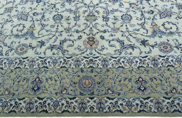 Corner detail of 2000s Kashan rug showing border pattern and Wool pile