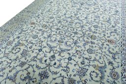 Backside of handmade 2000s Kashan rug showing knot structure and weave density