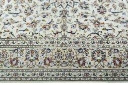 Corner detail of 2000s Kashan rug showing border pattern and Wool pile