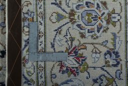 Backside of handmade 2000s Kashan rug showing knot structure and weave density