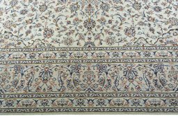 Corner detail of 2000s Kashan rug showing border pattern and Wool pile