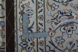 Backside of handmade 2000s Kashan rug showing knot structure and weave density