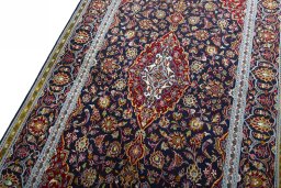 Backside of handmade New Kashan rug showing knot structure and weave density
