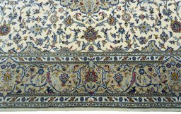 Corner detail of New Kashan rug showing border pattern and Cork pile