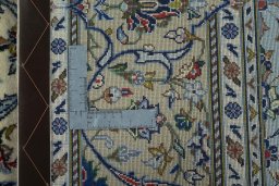 Backside of handmade New Kashan rug showing knot structure and weave density