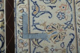 Backside of handmade New Kashan rug showing knot structure and weave density