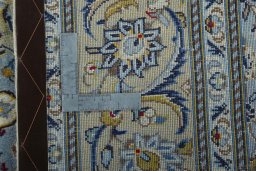 Backside of handmade New Kashan rug showing knot structure and weave density