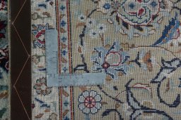Backside of handmade 1950s Kashan rug showing knot structure and weave density
